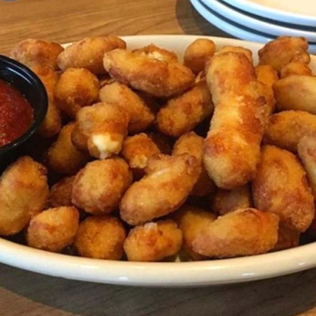 A bowl of fried cheese curds with dipping sauce, a tasty Food favorite in Holmen Wisconsin.