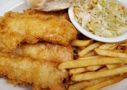 Golden fried fish, crispy fries, coleslaw, and a roll—classic food from our restaurant.