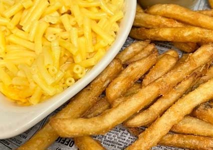 Close-up of macaroni and cheese in a dish with crispy French fries at a Holmen Wisconsin bar.