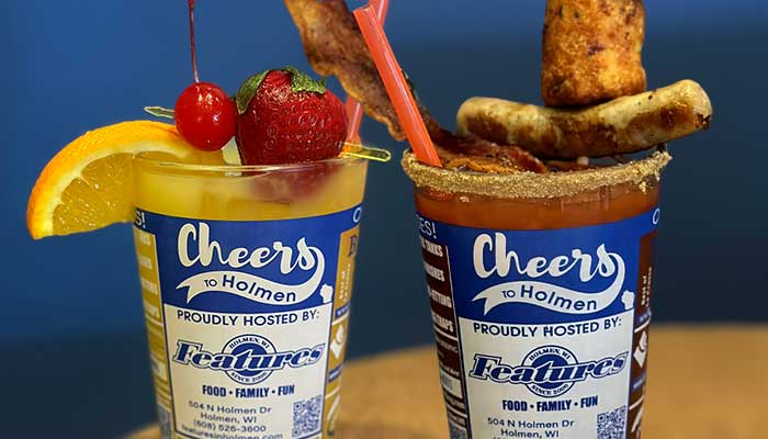 Two colorful drinks garnished with fruit, bacon, and cheese at Features Sports Bar & Grill.