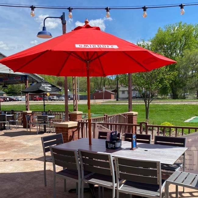 Outdoor patio seating at Features Sports Bar & Grill in Holmen Wisconsin on a sunny day.