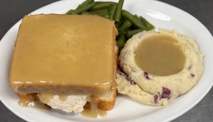 Open-faced turkey sandwich with gravy, mashed potatoes, and green beans at Features Sports Bar & Grill.