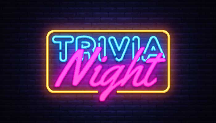 Neon sign on a brick wall at Features Sports Bar & Grill in Holmen, Wisconsin—drink and play!.